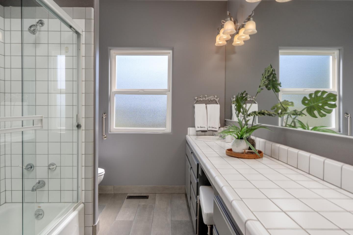 23715 Determine Lane Monterey, CA 93940 - Photo 36 of 43 a view of bathroom with a tub that has a sink and wooden floor