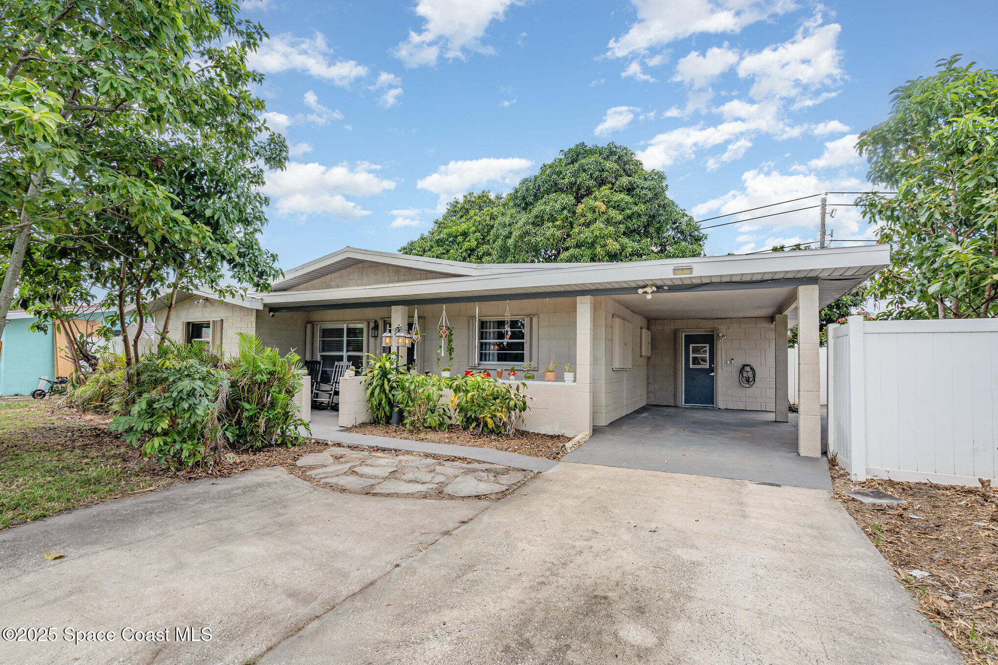 a front view of a house with a garden and porch