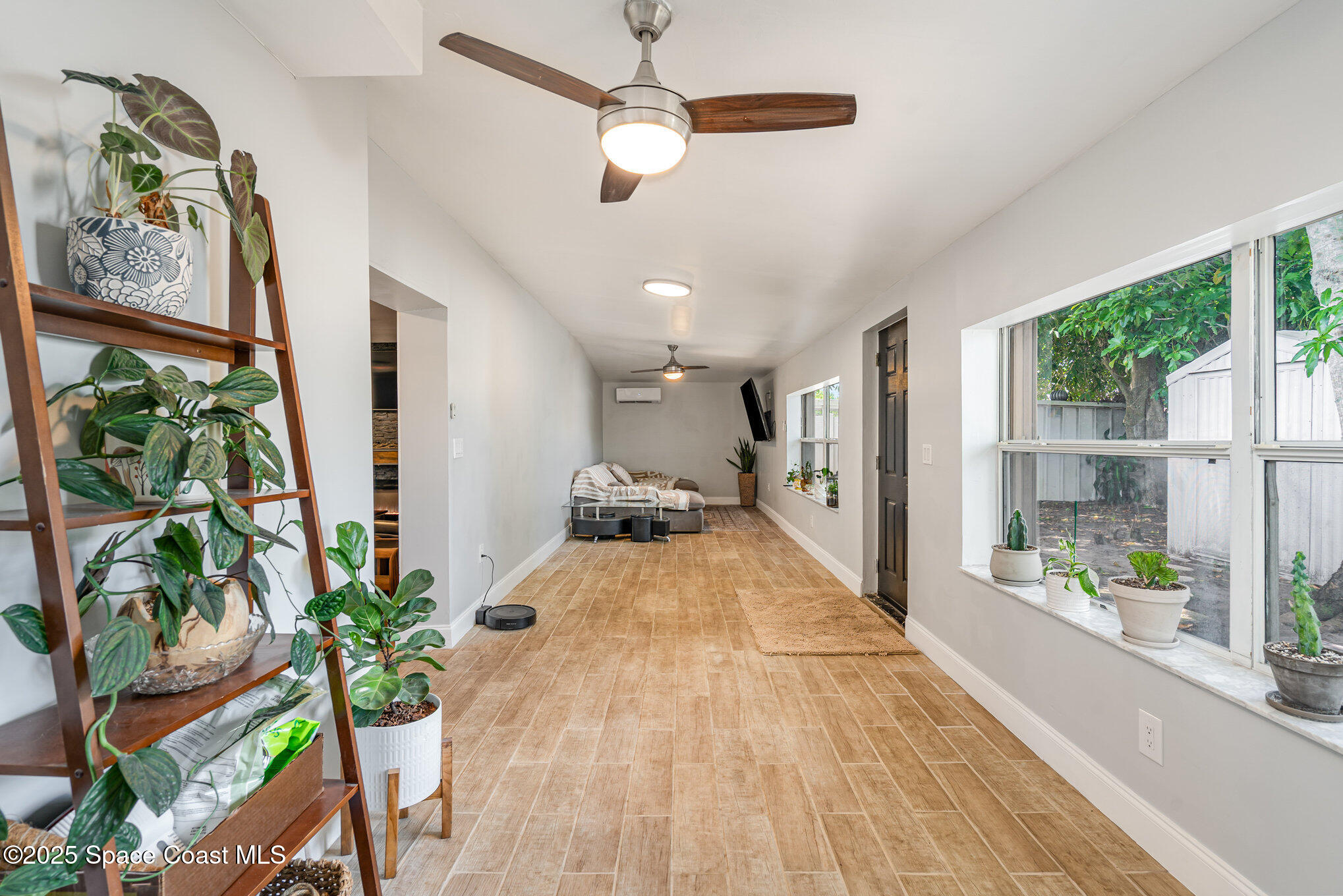 508 Comanche Avenue Melbourne, FL 32935 - Photo 12 of 21 a view of a living room and floor to ceiling windows