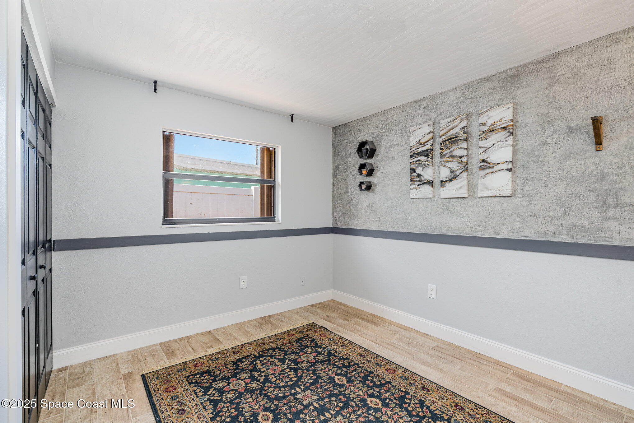 508 Comanche Avenue Melbourne, FL 32935 - Photo 14 of 21 a view of a room with window and hardwood floor