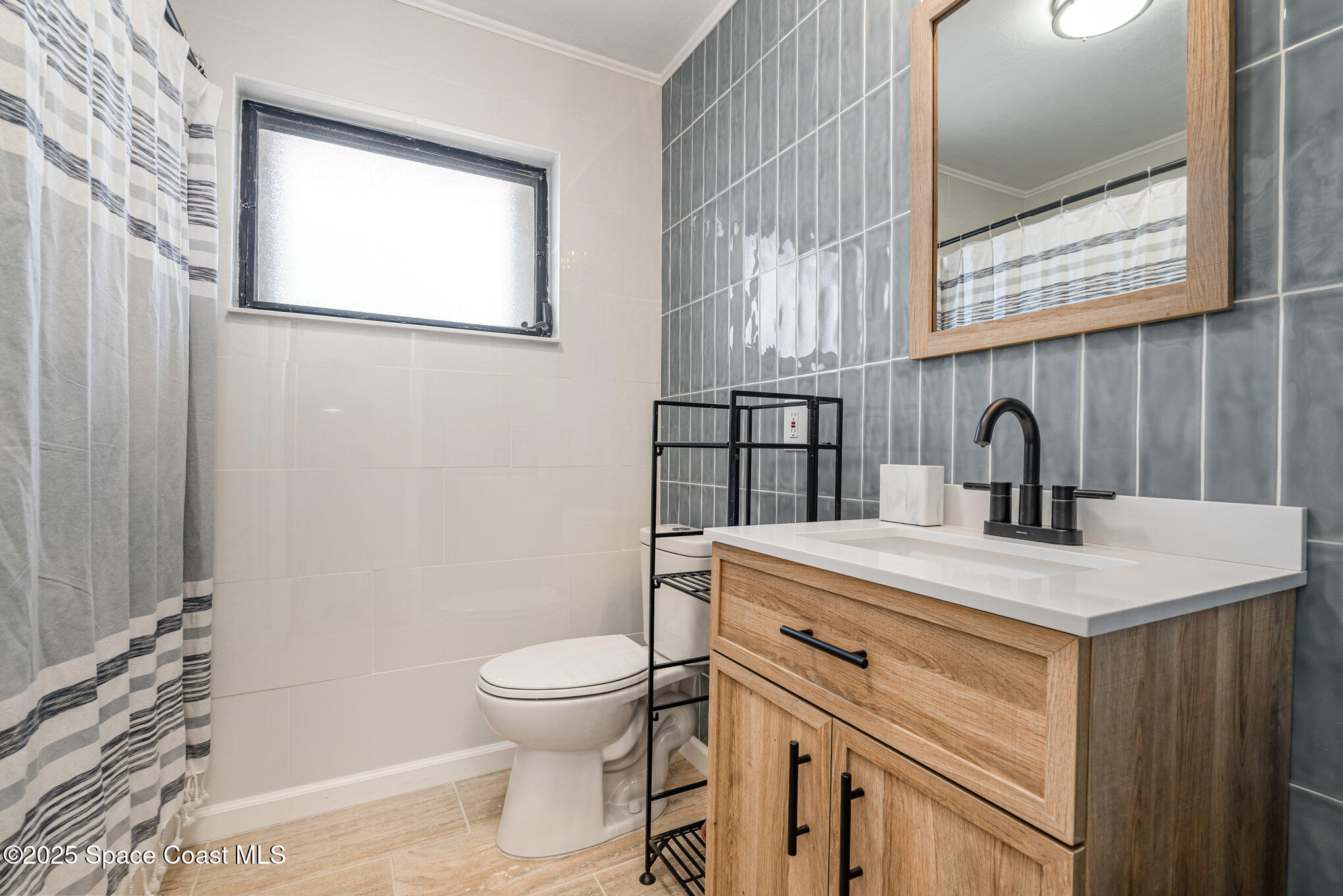 508 Comanche Avenue Melbourne, FL 32935 - Photo 15 of 21 a bathroom with a sink toilet and a mirror
