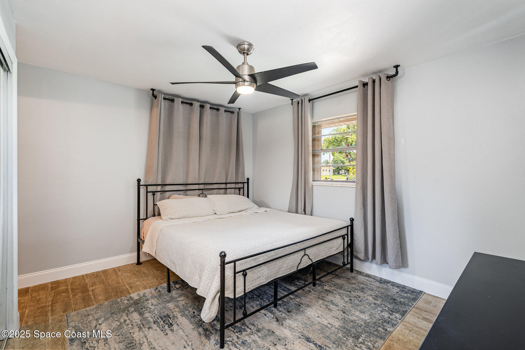 508 Comanche Avenue Melbourne, FL 32935 - Photo 16 of 21 a bed sitting in a spacious bedroom next to a window