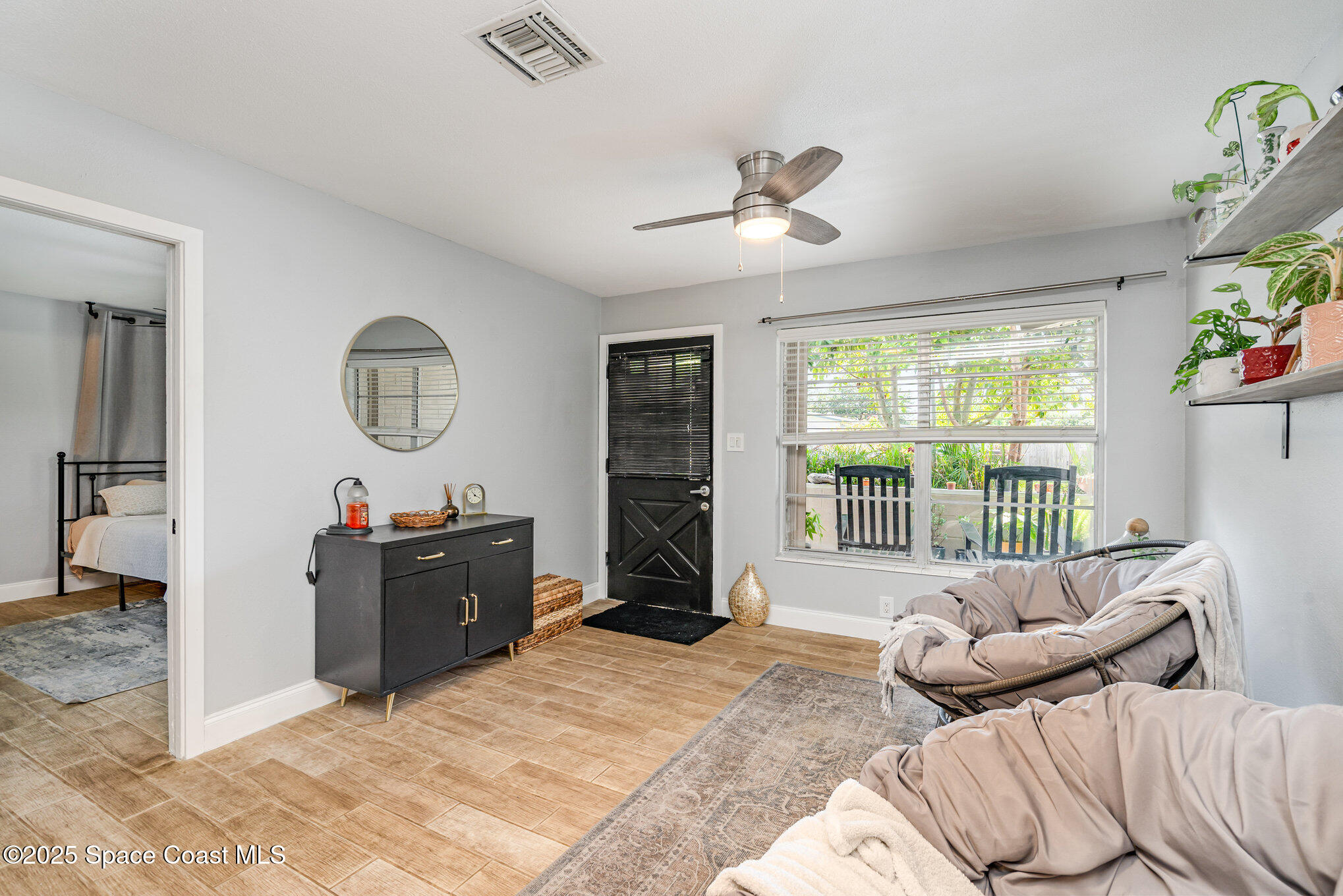 508 Comanche Avenue Melbourne, FL 32935 - Photo 4 of 21 a living room with furniture windows and a flat screen tv