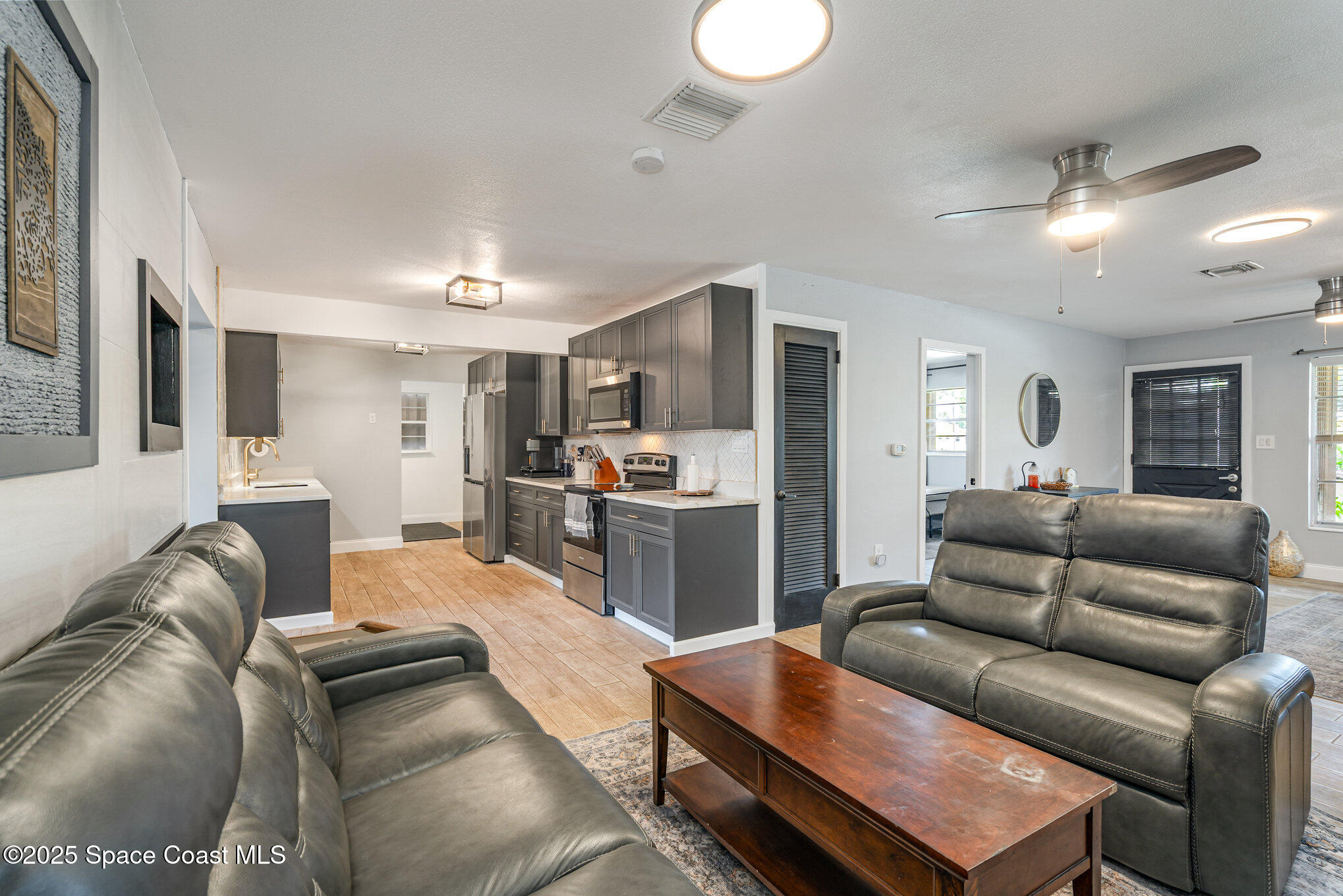 508 Comanche Avenue Melbourne, FL 32935 - Photo 5 of 21 a living room with furniture and kitchen view