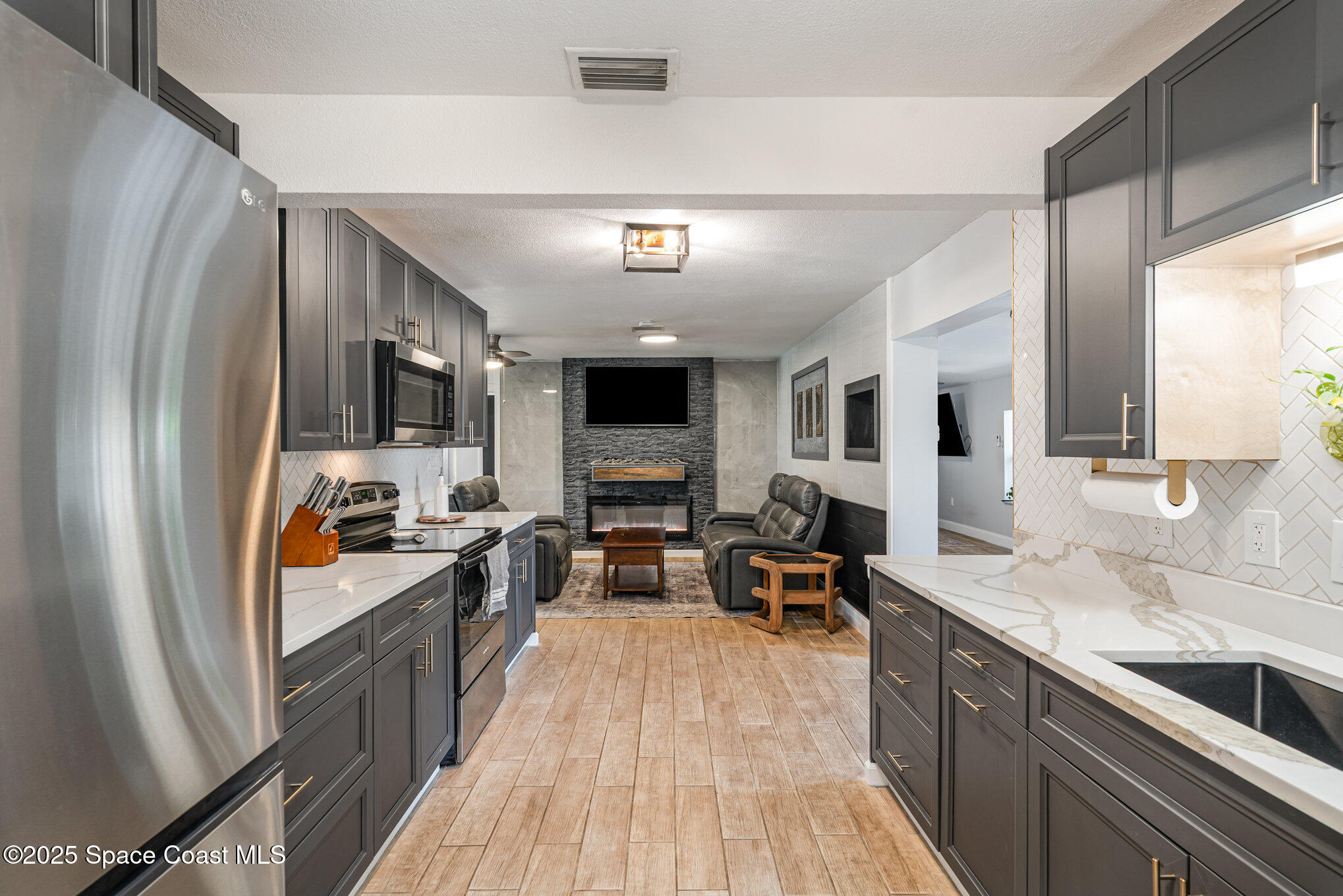508 Comanche Avenue Melbourne, FL 32935 - Photo 9 of 21 a kitchen with stainless steel appliances granite countertop a refrigerator stove and sink