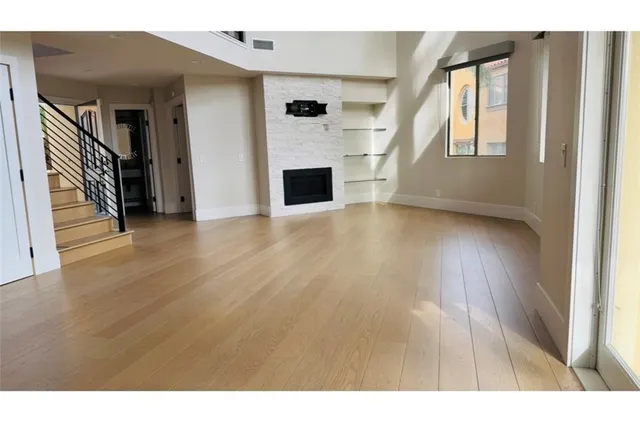 a view interior of a house with wooden floor fireplace and windows