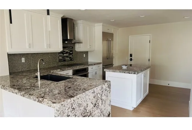 a kitchen with a sink stove and refrigerator