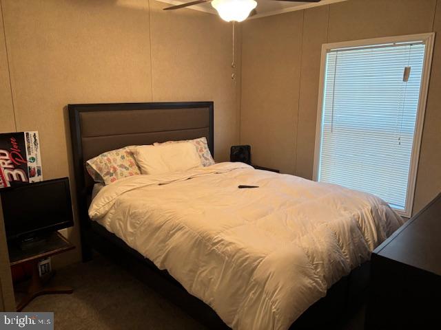 31706 Janice Road Lewes, DE 19958 - Photo 12 of 20 a bedroom with a bed and a night stand