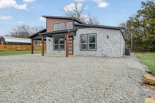 a front view of a house with garden