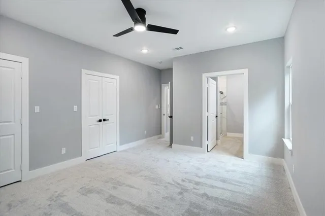 an empty room with fan and entrance