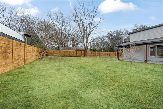 a view of a backyard with large trees