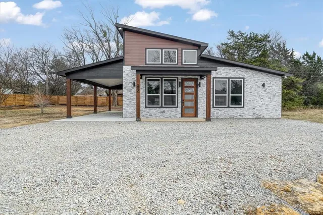 a view of a house with a porch and furniture