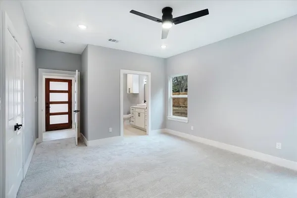 an empty room with closet and windows