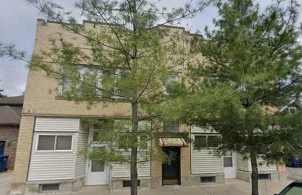 a front view of a house with trees