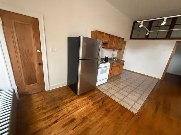 a kitchen with a refrigerator and a stove