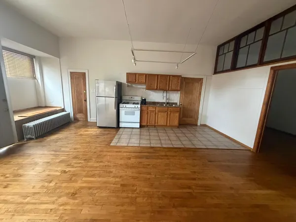 a view of kitchen with furniture and wooden floor