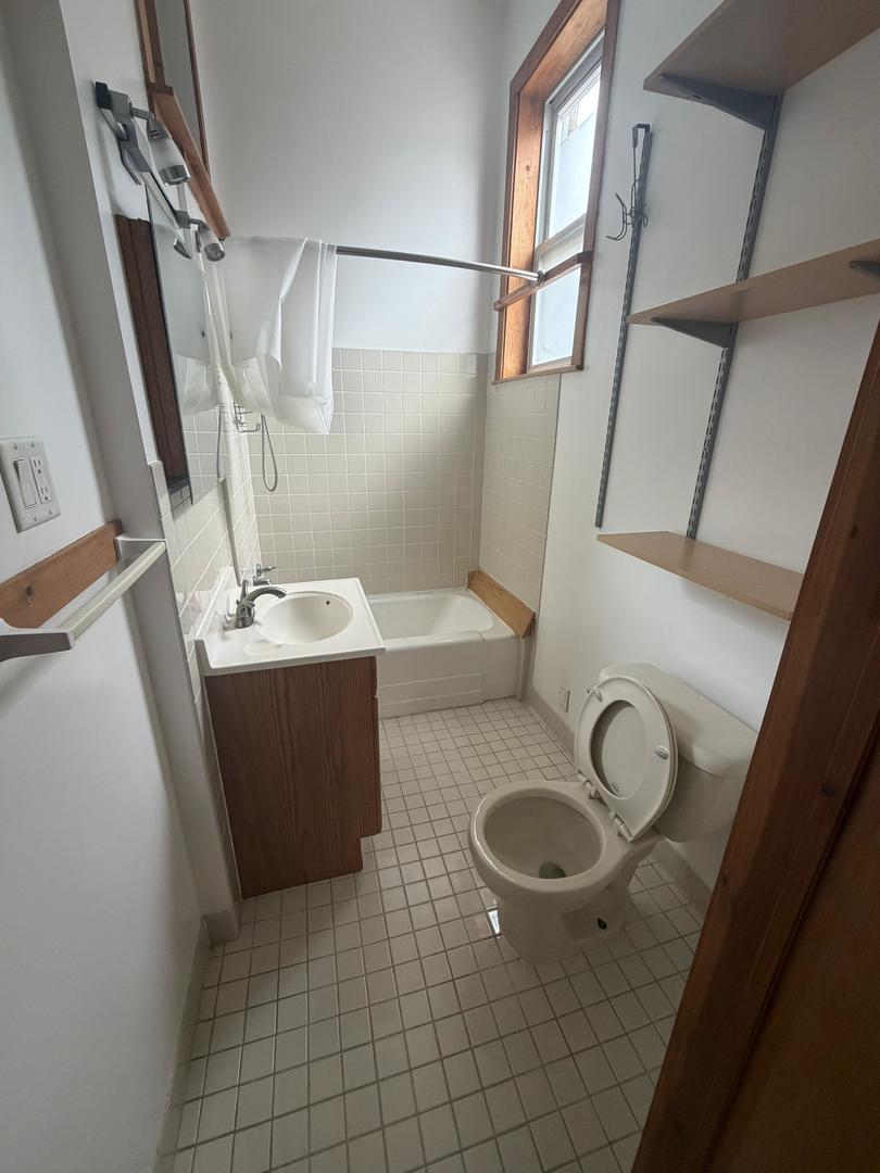 1014 East Prairie Avenue, Unit 1FE Des Plaines, IL 60016 - Photo 10 of 10 a bathroom with a sink a toilet and a mirror