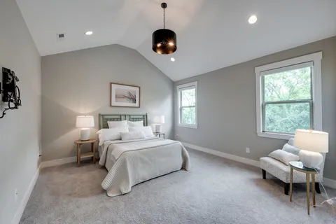 a spacious bedroom with a bed and a window