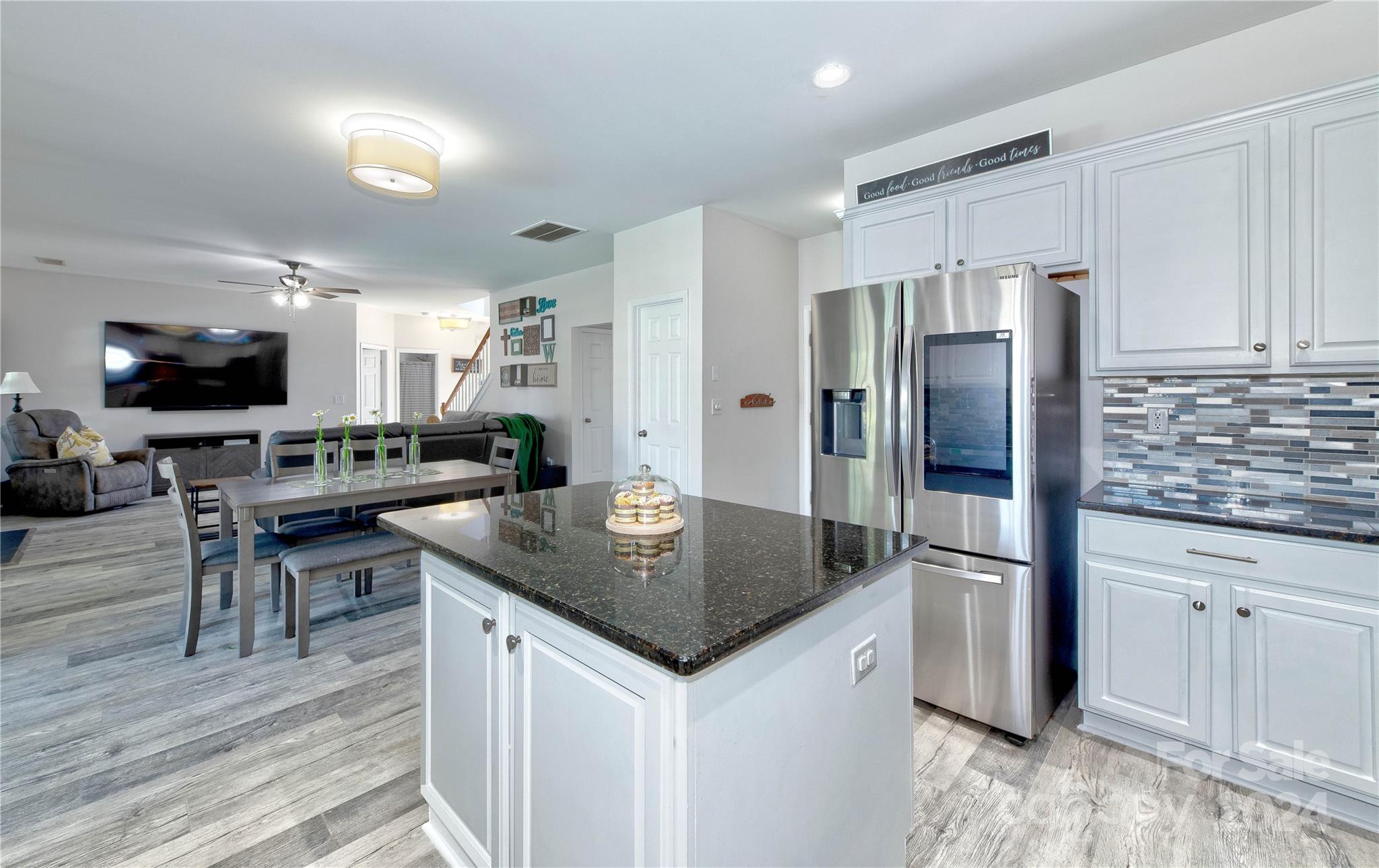 3002 Potomac Road Indian Trail, NC 28079 - Photo 13 of 48 a kitchen with stainless steel appliances granite countertop a refrigerator a stove a sink a dining table and chairs