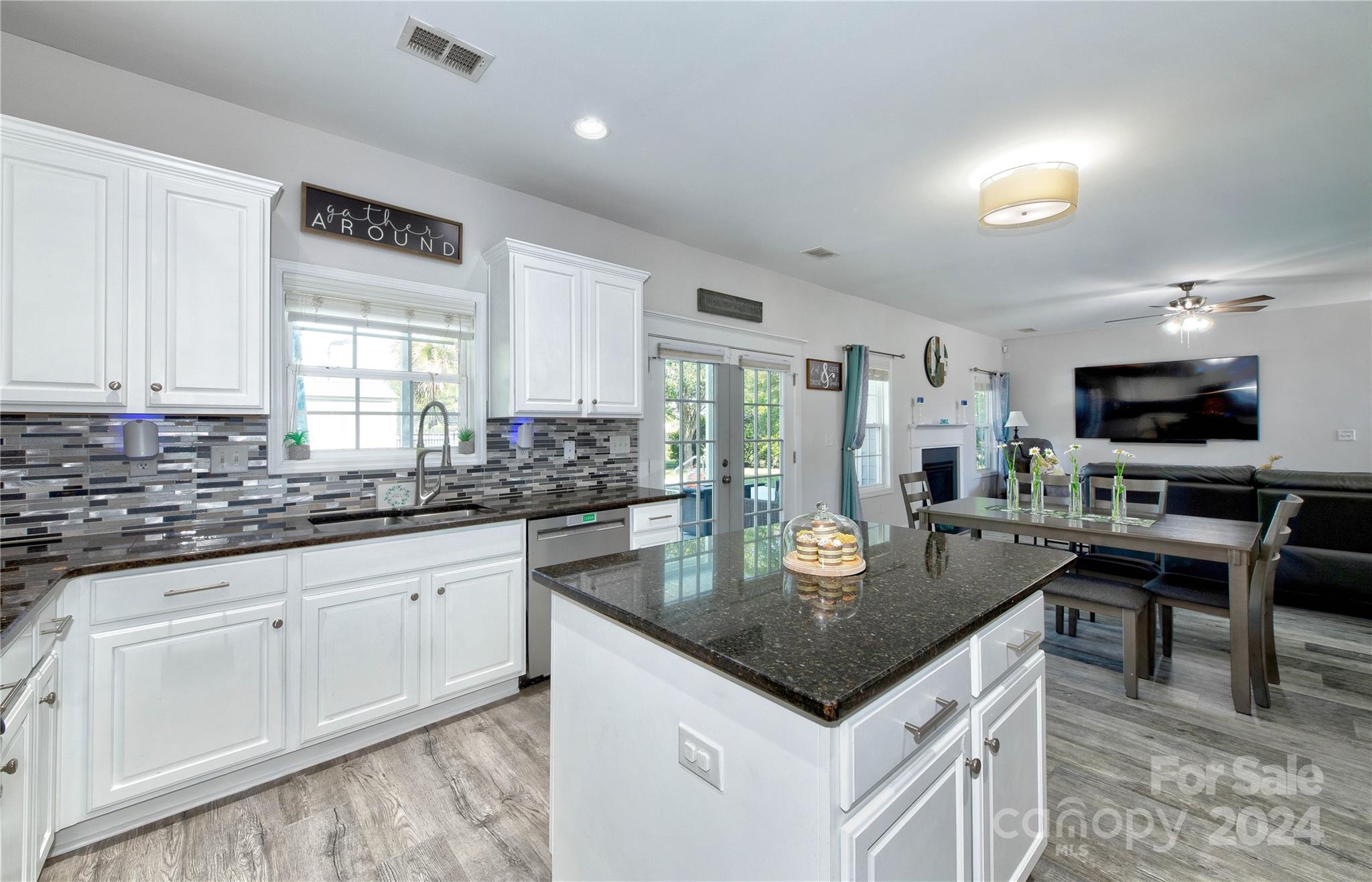 3002 Potomac Road Indian Trail, NC 28079 - Photo 14 of 48 a kitchen with granite countertop stainless steel appliances a table and chairs in it