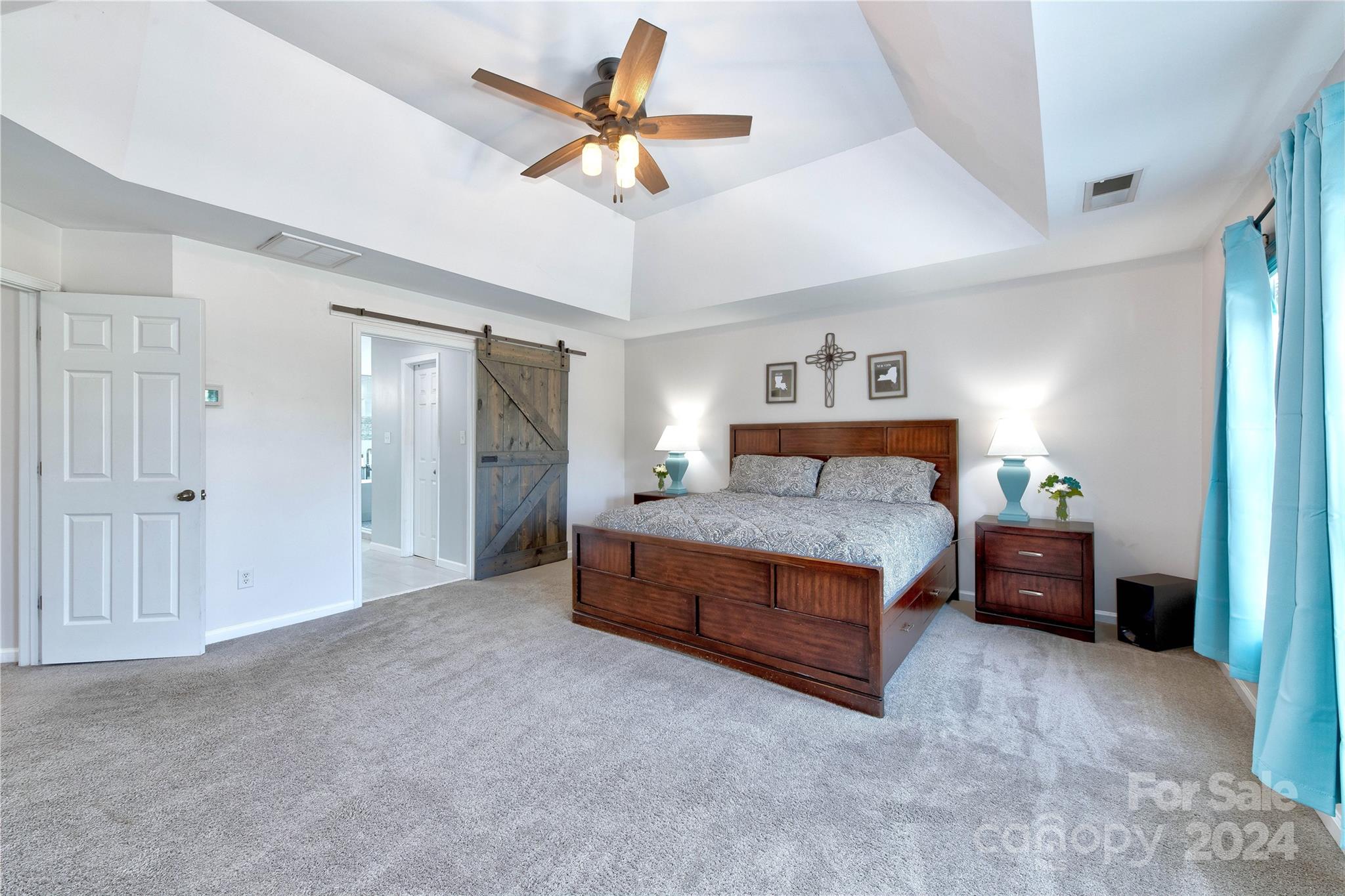 3002 Potomac Road Indian Trail, NC 28079 - Photo 27 of 48 a spacious bedroom with a bed and a chandelier