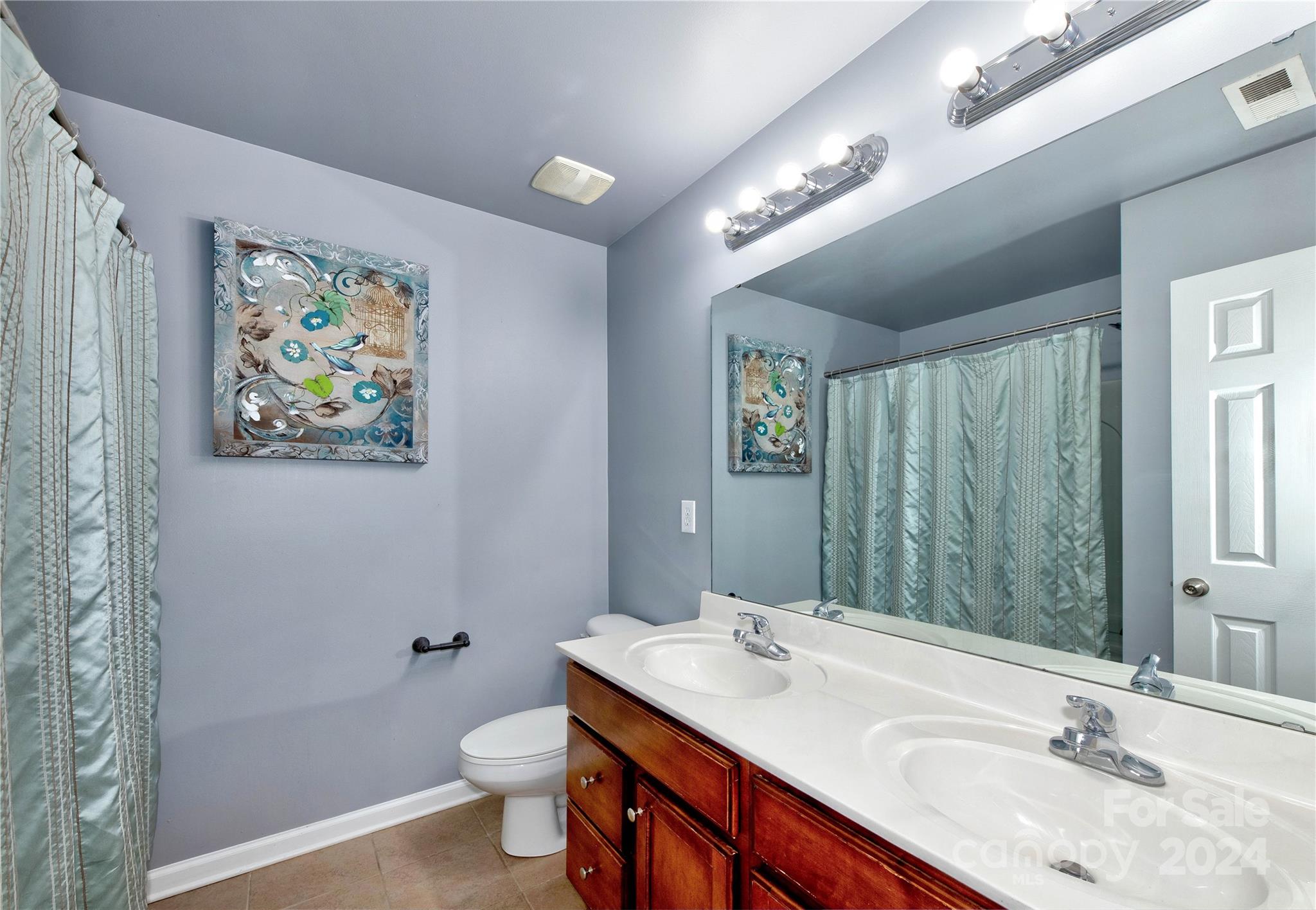 3002 Potomac Road Indian Trail, NC 28079 - Photo 36 of 48 a bathroom with a double vanity sink toilet and a mirror