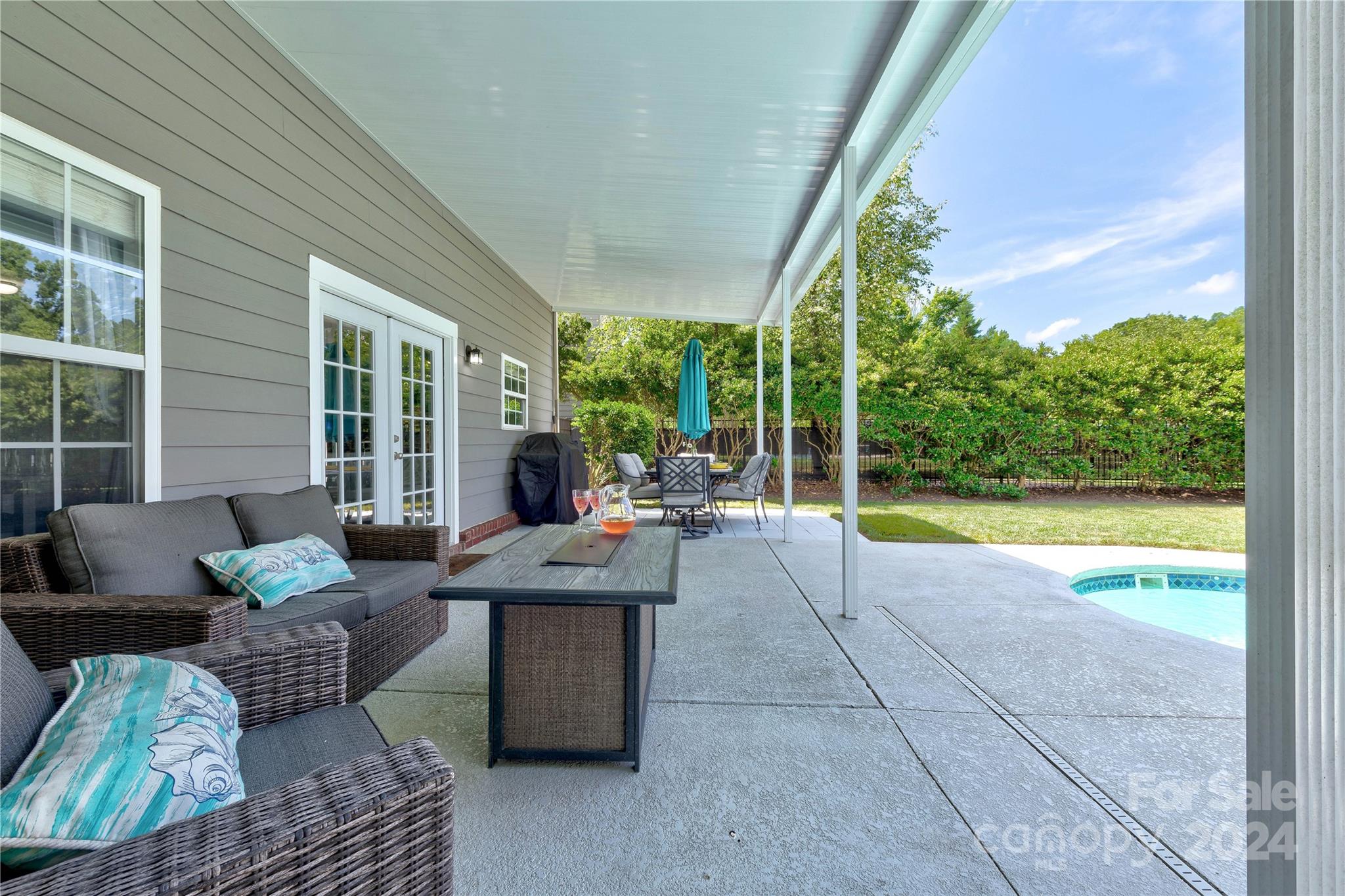 3002 Potomac Road Indian Trail, NC 28079 - Photo 41 of 48 a view of a patio with couches potted plants and floor to ceiling window