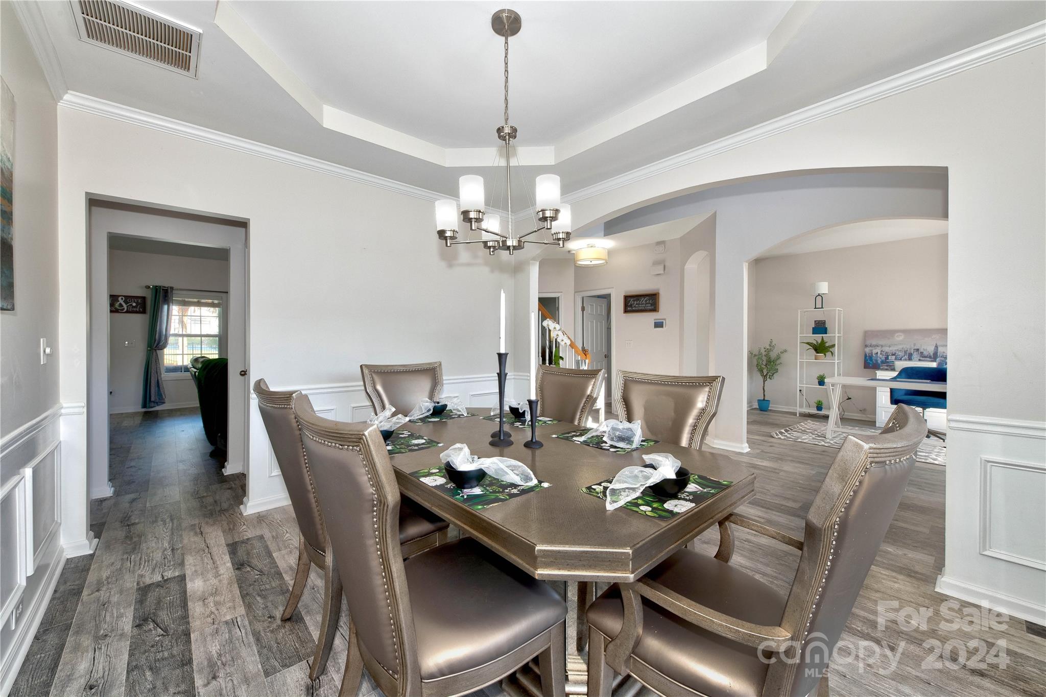 3002 Potomac Road Indian Trail, NC 28079 - Photo 9 of 48 a view of a dining room with furniture a chandelier and wooden floor