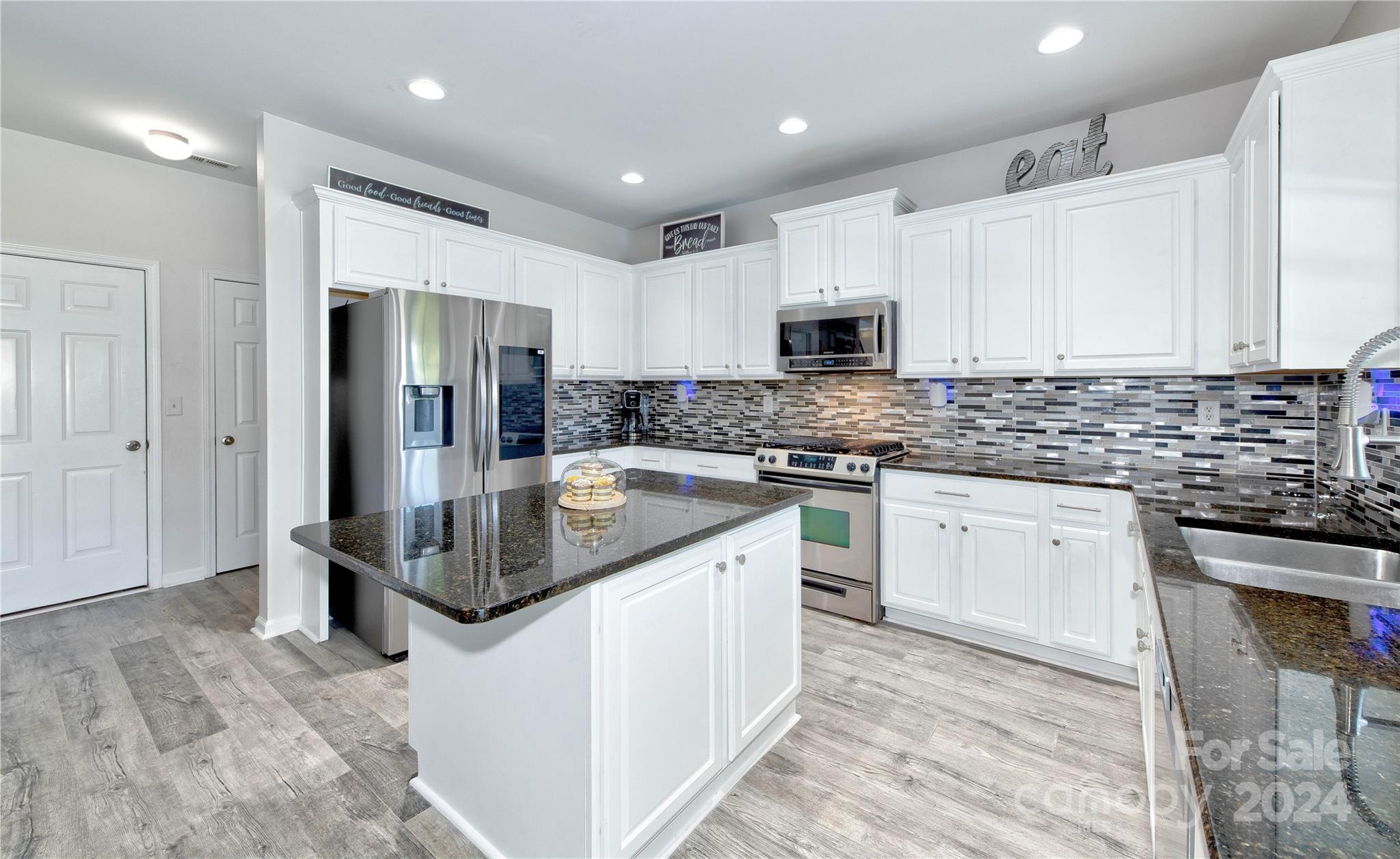 3002 Potomac Road Indian Trail, NC 28079 - Photo 10 of 48 a kitchen with stainless steel appliances granite countertop a stove a sink and a refrigerator