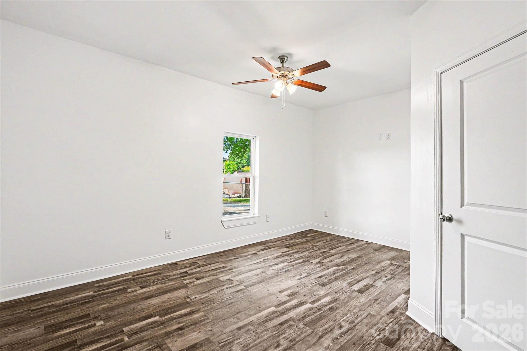 405 Aquadale Road Albemarle, NC 28001 - Photo 19 of 29 a view of empty room with wooden floor and fan