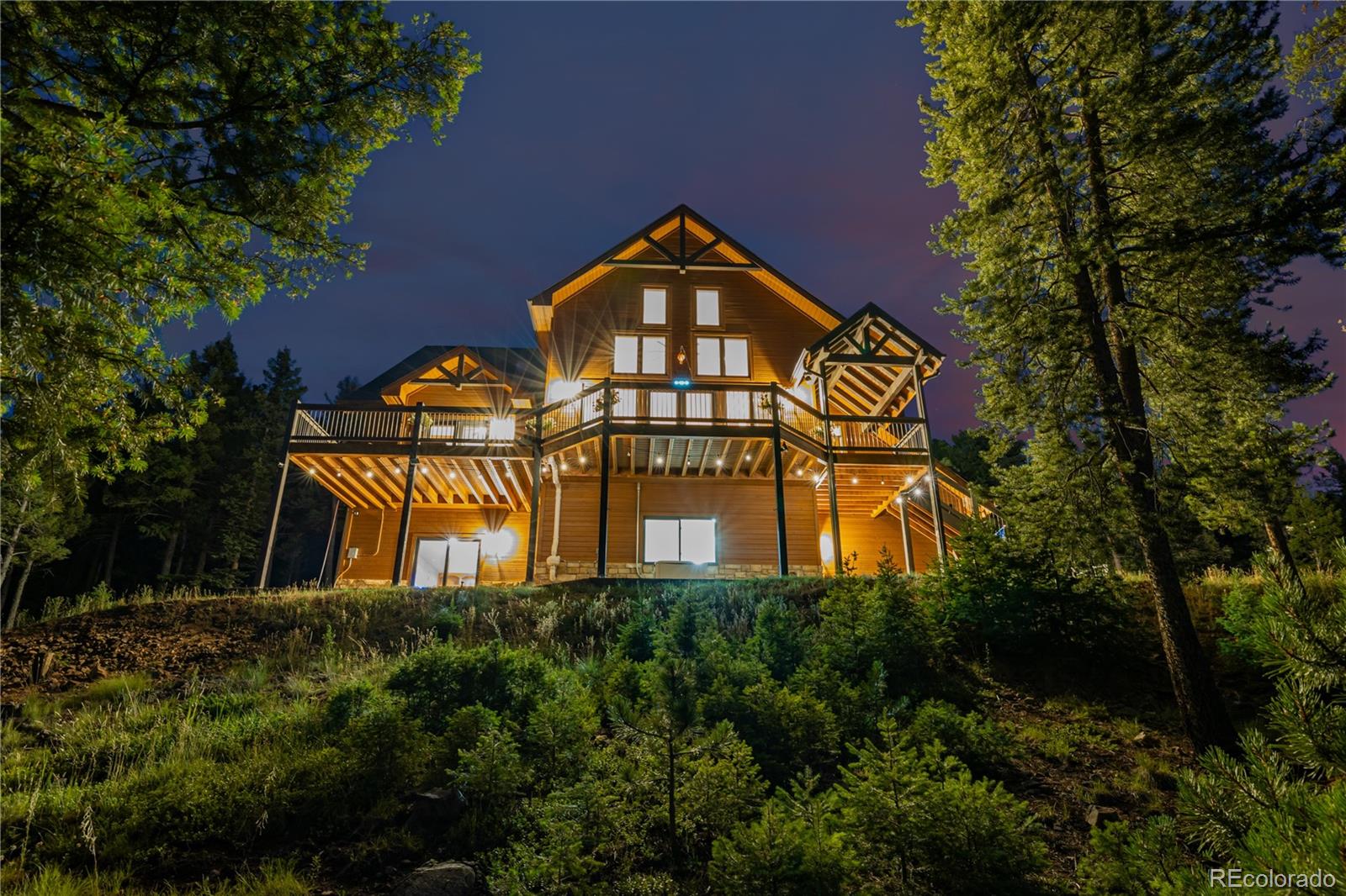 11272 Belle Meade Drive Conifer, CO 80433 - Photo 1 of 45 a view of a large brick building next to a yard