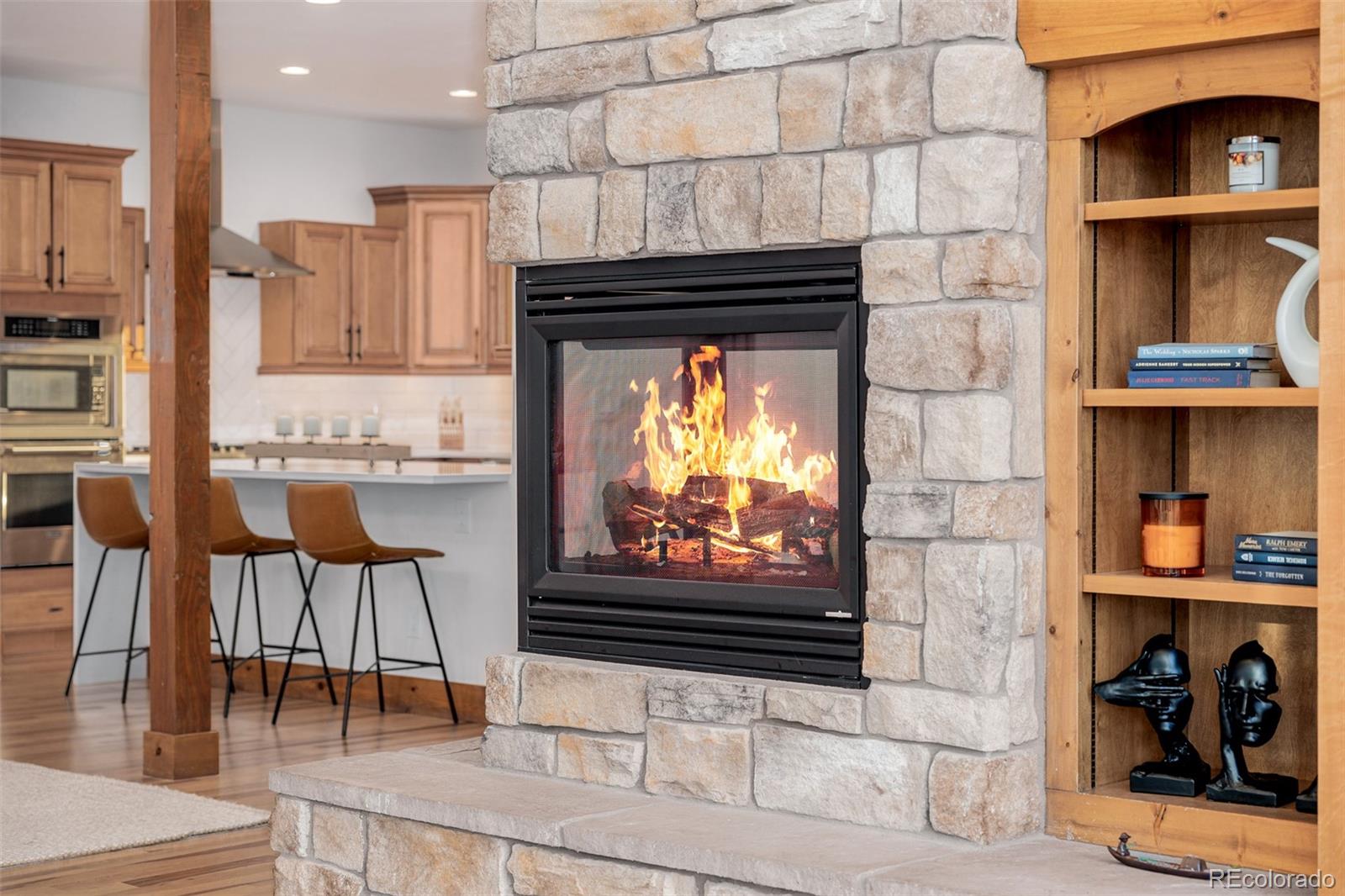 11272 Belle Meade Drive Conifer, CO 80433 - Photo 11 of 45 a kitchen with stainless steel appliances kitchen island granite countertop a stove and cabinets