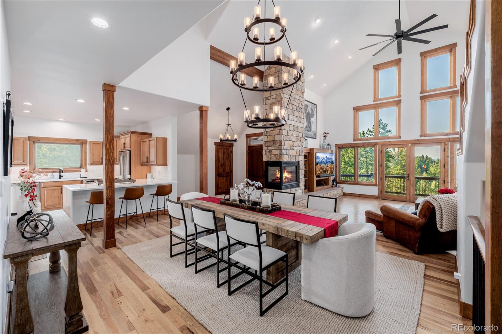 11272 Belle Meade Drive Conifer, CO 80433 - Photo 15 of 45 a living room with furniture a large window and a chandelier