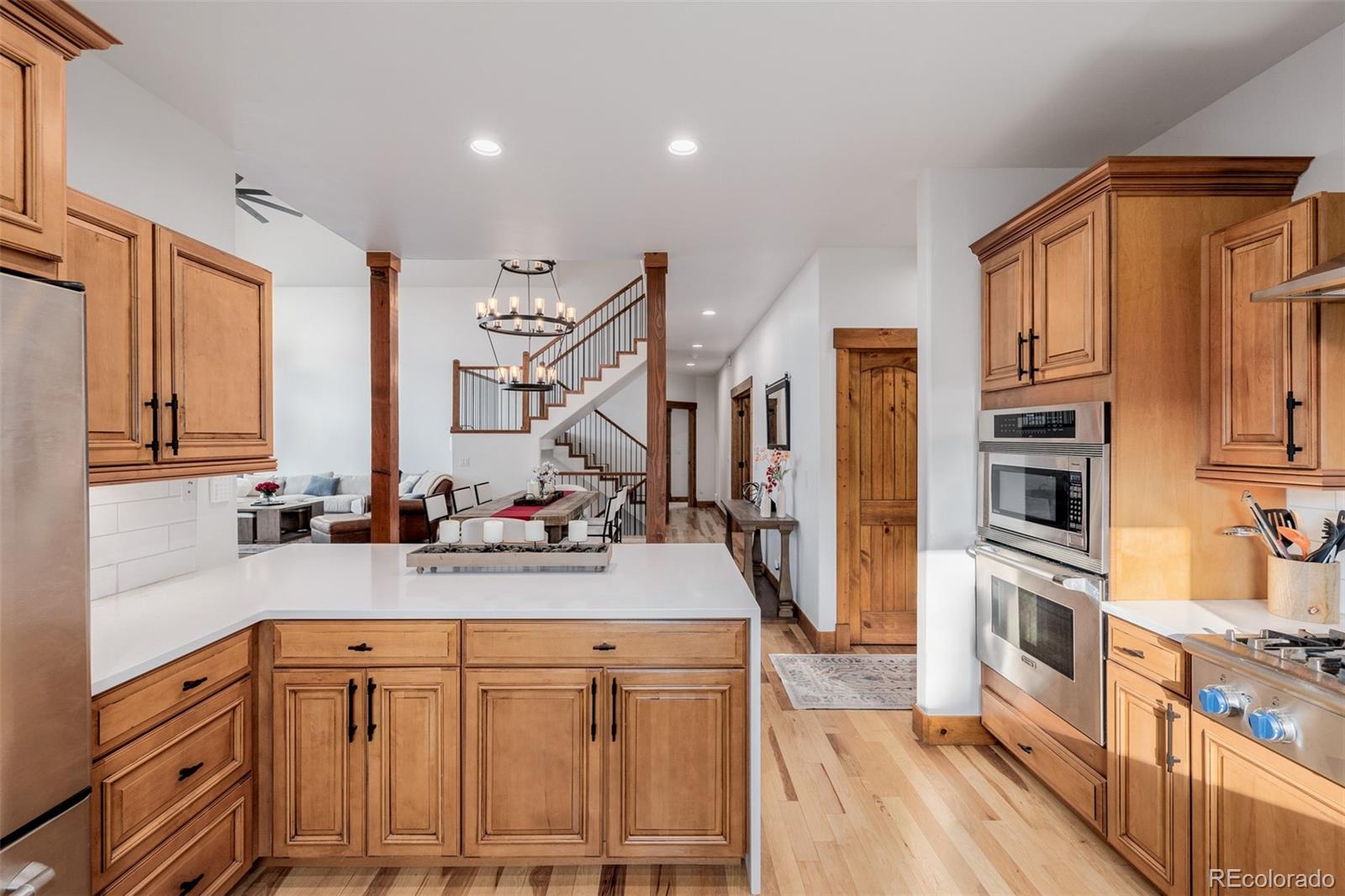 11272 Belle Meade Drive Conifer, CO 80433 - Photo 18 of 45 a kitchen with stainless steel appliances sink stove refrigerator and cabinets
