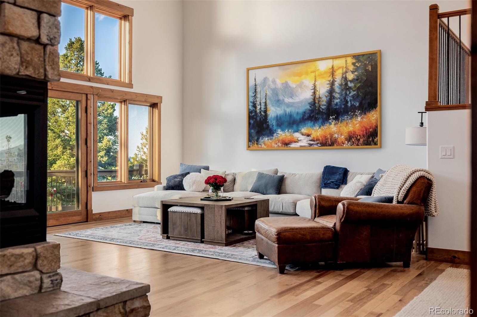 11272 Belle Meade Drive Conifer, CO 80433 - Photo 20 of 45 a living room with furniture a flat screen tv and a large window