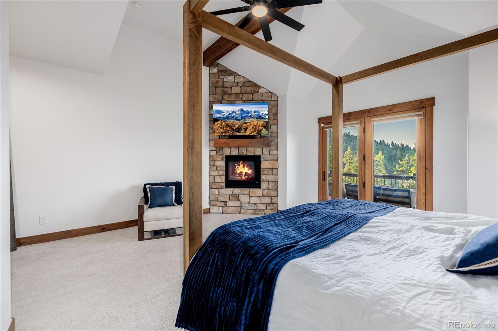 11272 Belle Meade Drive Conifer, CO 80433 - Photo 25 of 45 a bedroom with a bed and a chair