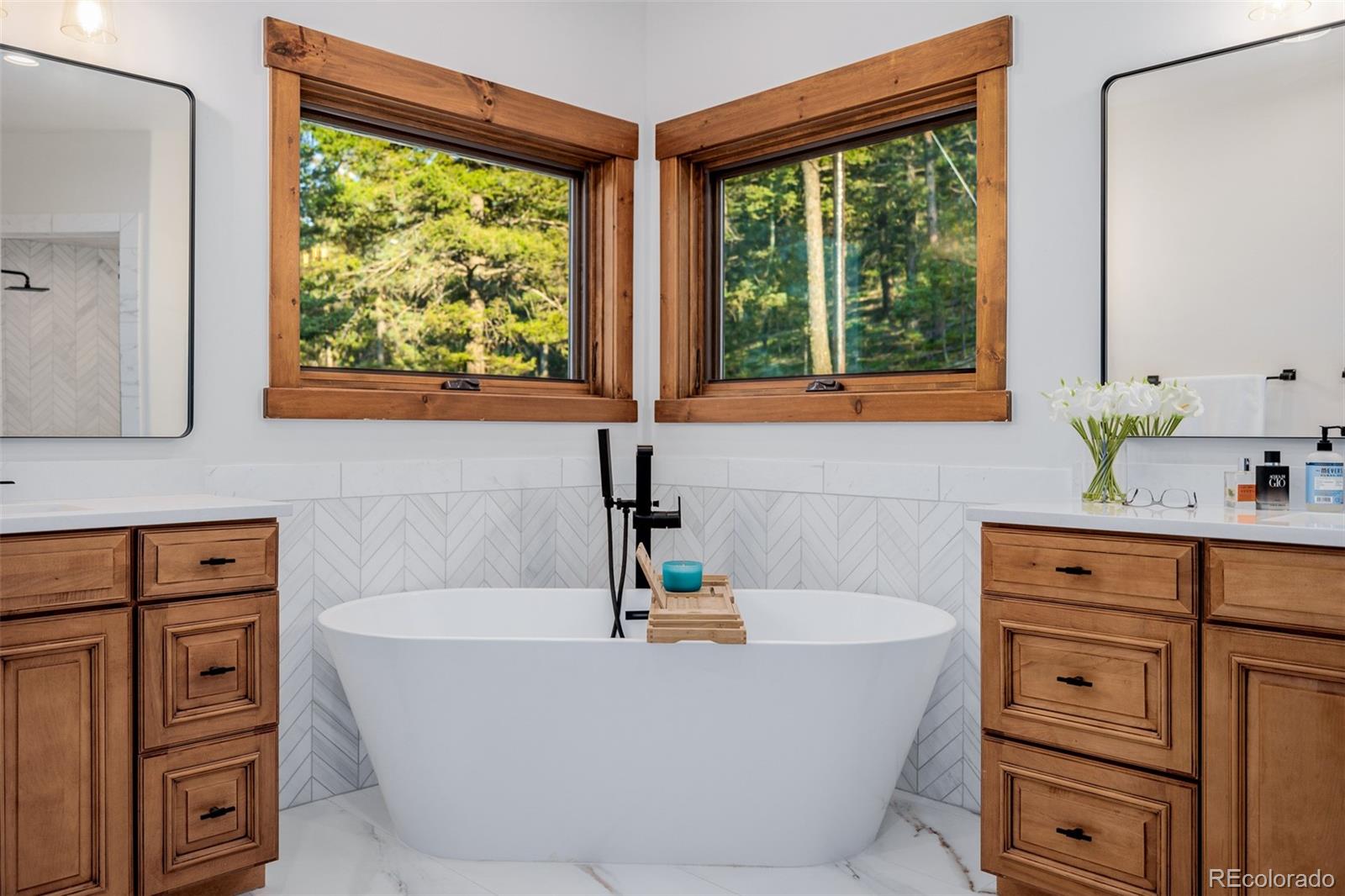 11272 Belle Meade Drive Conifer, CO 80433 - Photo 27 of 45 a bathroom with a bathtub and sink