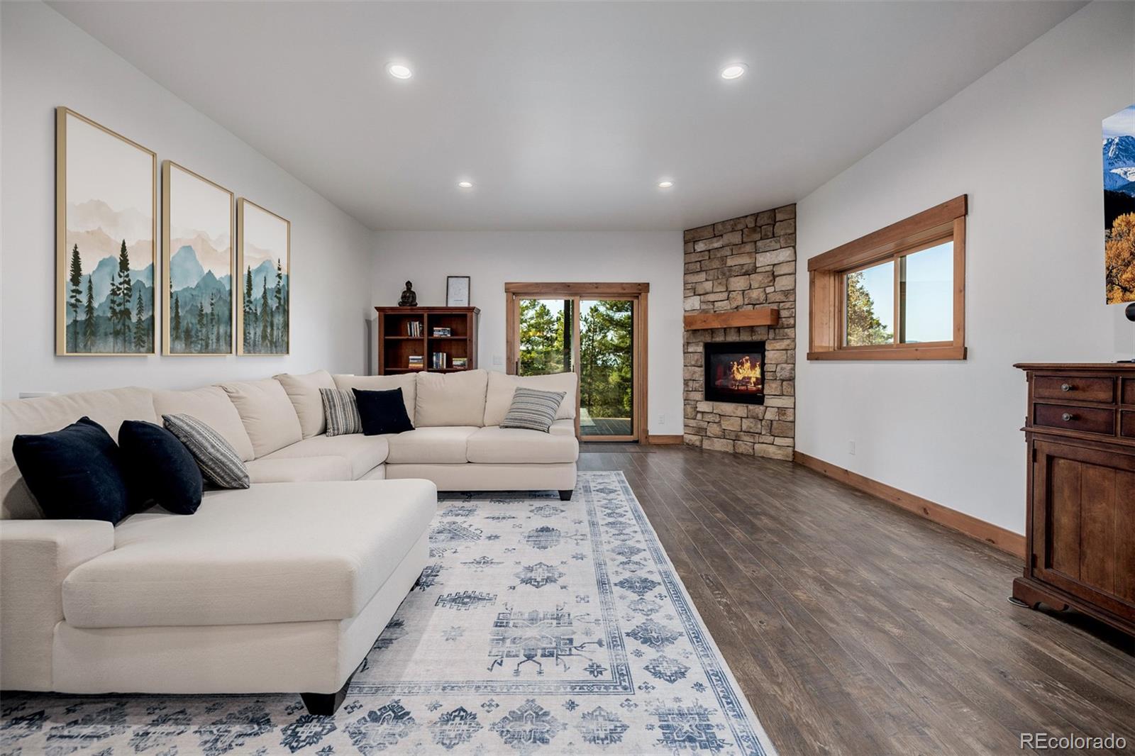 11272 Belle Meade Drive Conifer, CO 80433 - Photo 35 of 45 a living room with furniture and a fireplace