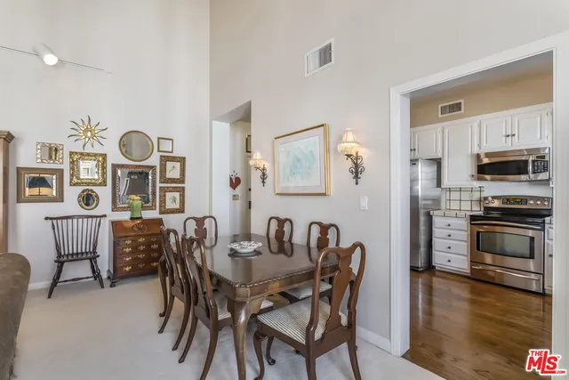 a dining room with furniture and wooden floor
