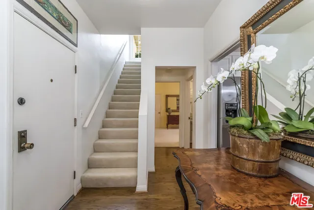 a view of entryway and hall with wooden floor