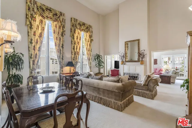 a living room with fireplace furniture and a large window