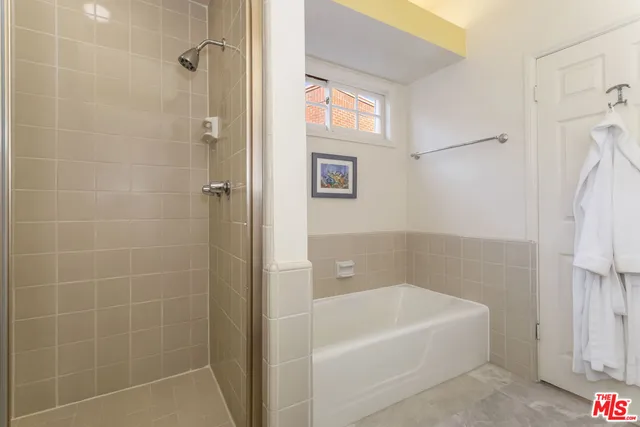 a bathroom with a bathtub and shower