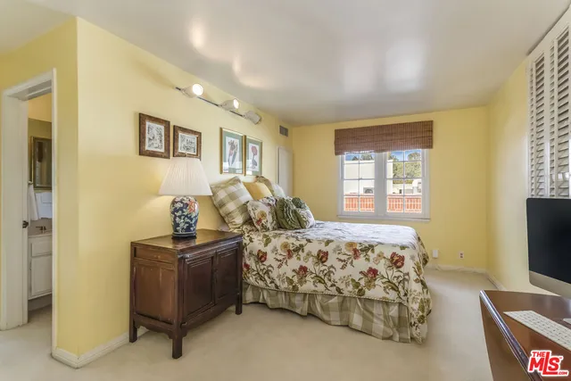 a bedroom with furniture and a flat screen tv