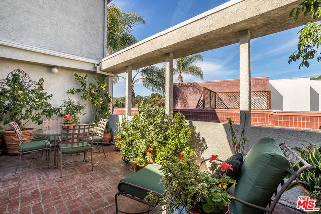 a view of a chairs and table in a patio