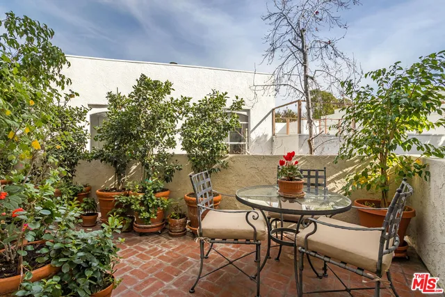 a view of a chairs and table in the patio