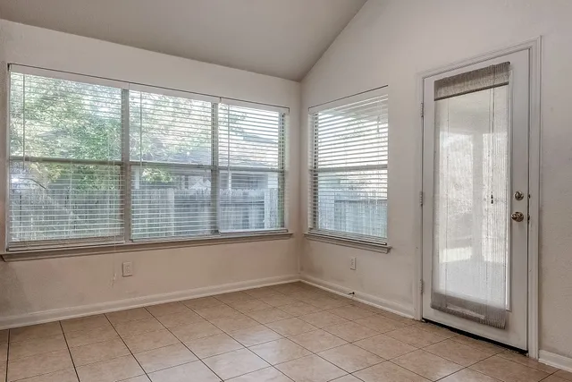 a view of a livingroom with a fireplace and a chandelier fan