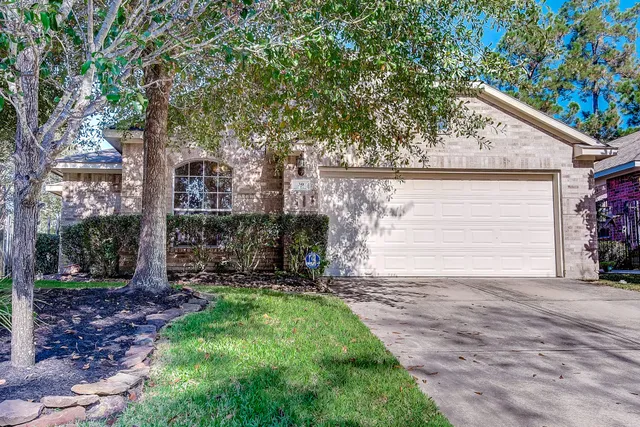 a view of a house with a yard and pathway