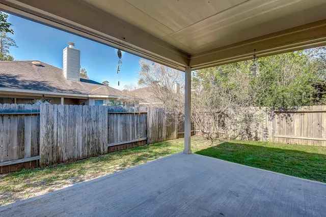 a view of a backyard with wooden fence
