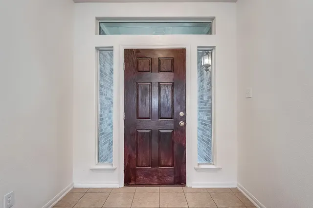 wooden floor in a room with a chandelier fan