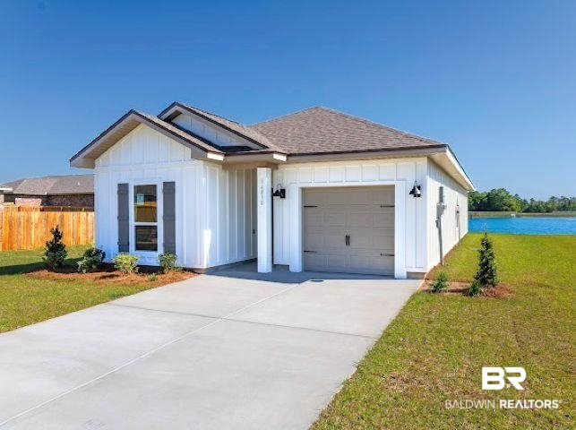 16810 Rocher Court Foley, AL 36535 - Photo 3 of 24 Modern farmhouse-style exterior featuring vertical white siding, a single-car garage with decorative hardware, and dark window shutters